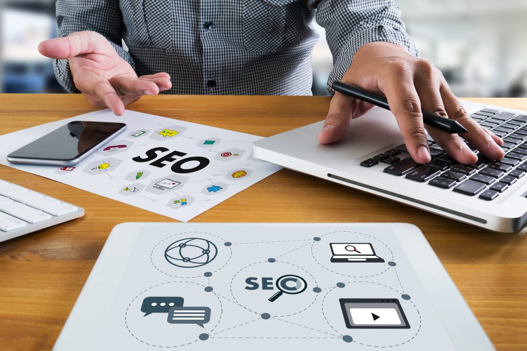 Local SEO Concept Business team hands at work with financial reports Links Global Hyperlink search engine optimization and a laptop