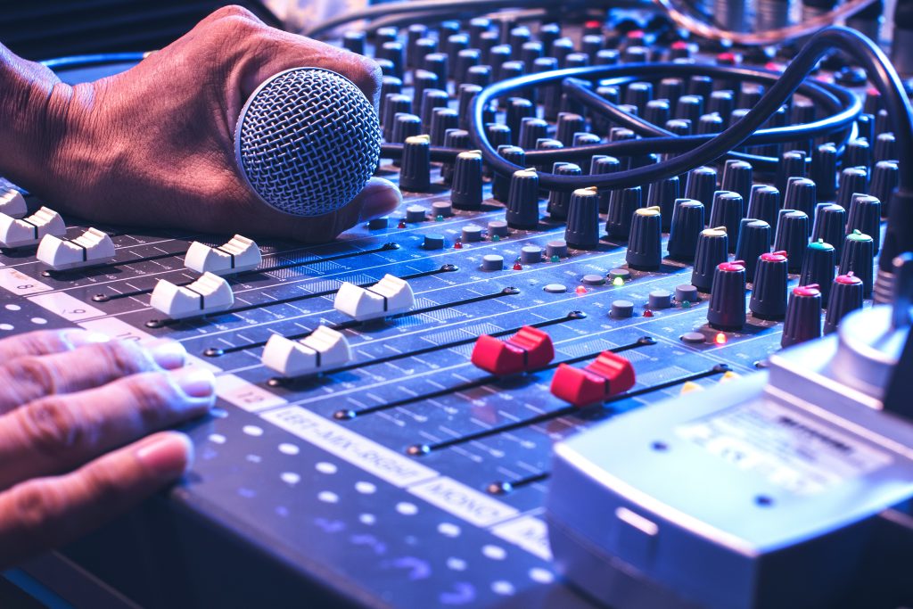 Man's hands control the sound.