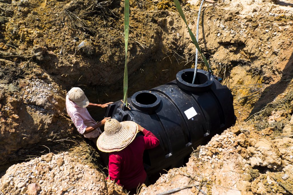 Septic tank installation in hole.